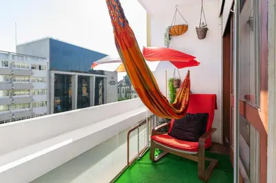 a hammock and a chair on a balcony at Sunny Oporto, Trindade Balcony in Porto