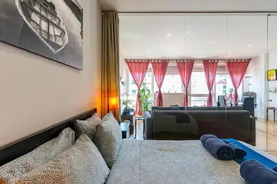 a bedroom with a bed and a living room at Sunny Oporto, Trindade Balcony in Porto