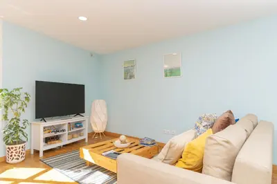 a person sitting on a couch in a living room at Sunny Oporto, Douro Apartments in Porto