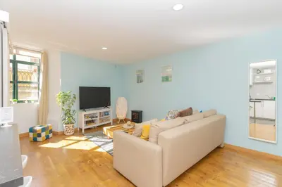 a living room with a couch and a flat screen tv at Sunny Oporto, Douro Apartments in Porto