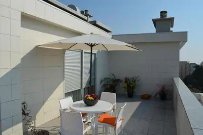 a patio with a table and chairs and an umbrella at Musical View in Porto
