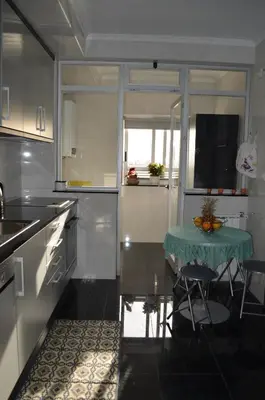 a kitchen with a table with a green table cloth on it at Musical View in Porto