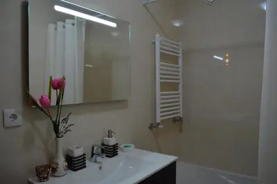 a bathroom with a sink and a shower with a mirror at Musical View in Porto