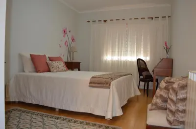 a bedroom with a bed and a desk and a chair at Musical View in Porto