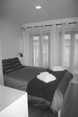 a bedroom with a bed with towels on it at Be In Oporto in Porto