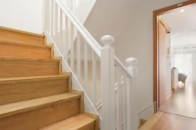 a staircase in a home with white walls and wooden floors at Be In Oporto in Porto