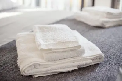 a pile of white towels sitting on top of a counter at Be In Oporto in Porto