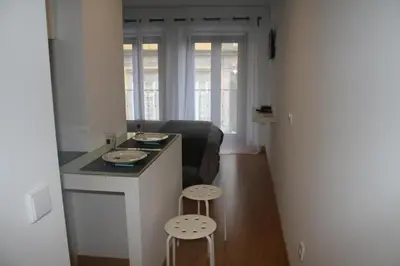 a small kitchen with a counter and two stools at Be In Oporto in Porto