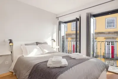 a bedroom with a large bed with two towels on it at Be In Oporto in Porto