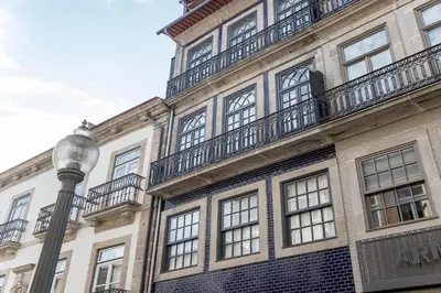 a building with a street light in front of it at Bright 3BR Flat w/ AC in City Center by LovelyStay in Porto