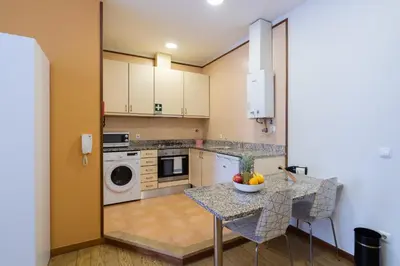 a kitchen with a table and a dishwasher at Host Wise - Urban Stylish Flat - Ace Location in Porto