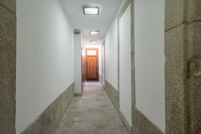 an empty corridor with a door and a hallway at Host Wise - Urban Stylish Flat - Ace Location in Porto