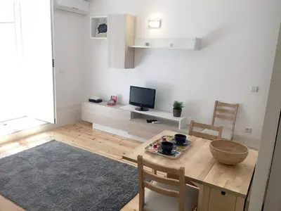 a living room with a table and a television at Quiet Apartment with Terrace in the Heart of Porto by Great&Cosy in Porto