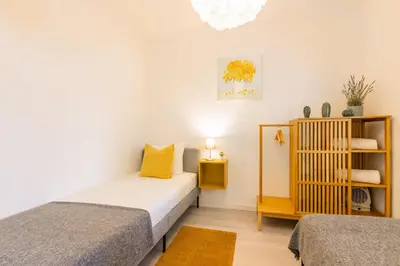a bedroom with a bed and a window at Casa Azul @ Jardim do Morro by BnBird in Vila Nova de Gaia