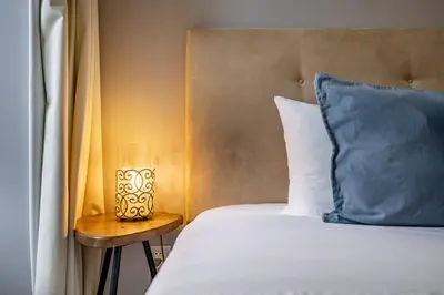 a bedroom with a large bed with two pillows at Oporto Wine Cellars Flat With Terrace in Vila Nova de Gaia