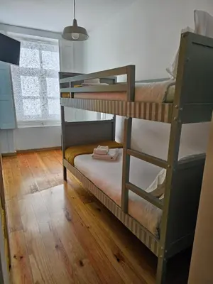 two bunk beds in a room with wooden floors at Douro View House Ribeira in Porto