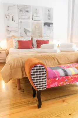 a bedroom with a bed with a table on it at Douro View House Ribeira in Porto