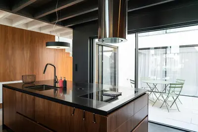 a kitchen with a black counter and a dining room at Arty Porto in Porto