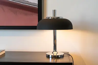 a black and silver lamp sitting on a desk at Arty Porto in Porto