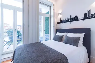 a bedroom with a large bed and a balcony at ON Apartments - Lapa Deluxe in Porto