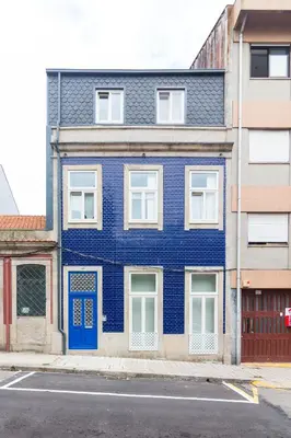 a blue building with a blue door on a street at ON Apartments - Lapa Deluxe in Porto