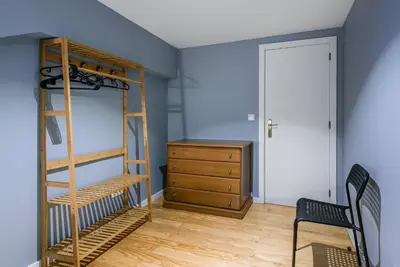 a bedroom with a bunk bed and a wooden dresser at GuestReady - Miragaia Rooftop in Porto