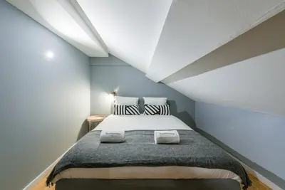 a bedroom with a large bed in a attic at GuestReady - Miragaia Rooftop in Porto