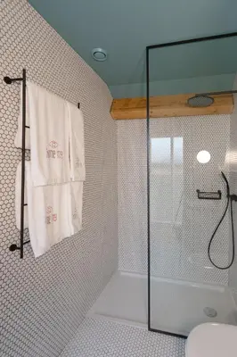 a bathroom with a shower and a towel on a wall at HM - Infante Riverside Apartment R in Porto