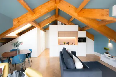a living room with blue walls and wooden ceilings at HM - Infante Riverside Apartment R in Porto