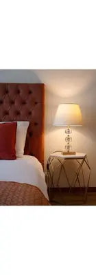 a bedroom with a bed with a lamp on a table at Gaia Douro Apartment in Vila Nova de Gaia