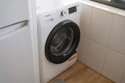 a white washer and dryer in a kitchen at Gaia Douro Apartment in Vila Nova de Gaia