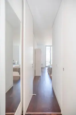 a room with white walls and a hallway with a bed at Liiiving in Porto - Carlos Alberto Apartment in Porto