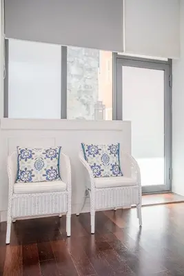 two chairs with blue and white pillows in a room at Liiiving in Porto - Carlos Alberto Apartment in Porto