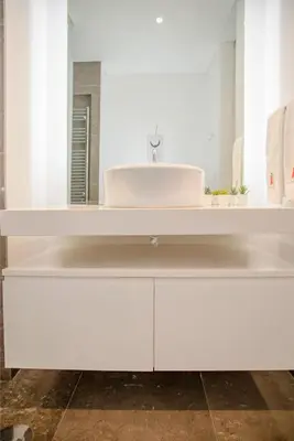 a white bathroom with a sink and a mirror at Liiiving in Porto - Carlos Alberto Apartment in Porto