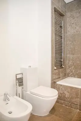 a bathroom with a toilet and a sink and a tub at Liiiving in Porto - Carlos Alberto Apartment in Porto