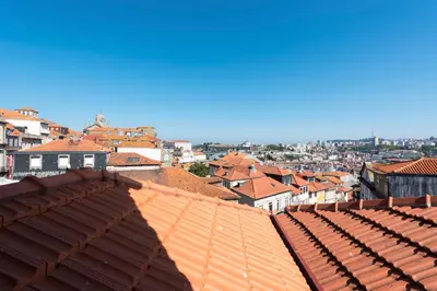 a view of a city with red roofs at Tripas Coração Taipas Historical Center in Porto