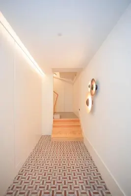 a staircase in a house with white walls and wood floors at Liiiving in Porto - Ribeira Design Apartment in Porto