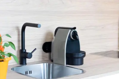 a coffee maker sitting on top of a kitchen sink at HM - Infante Riverside Apartment M in Porto
