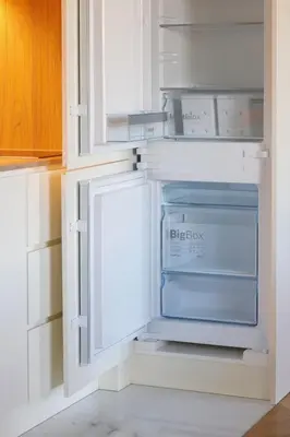 an empty refrigerator in a white kitchen at HM - Infante Riverside Apartment M in Porto