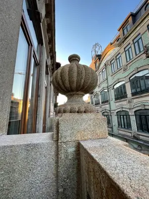 a stone statue in front of a building at Formosa Apartments in Porto