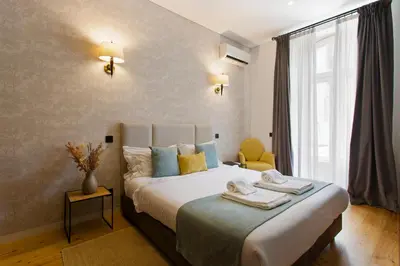 a bedroom with a bed with towels on it at BOUTIQUE Rentals-Art & Charm II Apt w/ Terrace in Porto