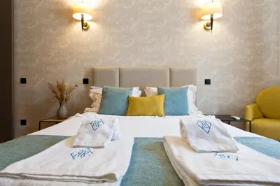 a bedroom with a large bed with towels on it at BOUTIQUE Rentals-Art & Charm II Apt w/ Terrace in Porto