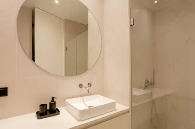 a white bathroom with a sink and a mirror at BOUTIQUE Rentals-Art & Charm II Apt w/ Terrace in Porto