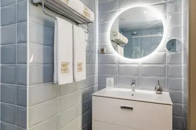 a bathroom with a white sink and a mirror at Legends House by Sweet Porto in Porto