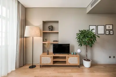 a living room with a television on a wooden cabinet at Legends House by Sweet Porto in Porto