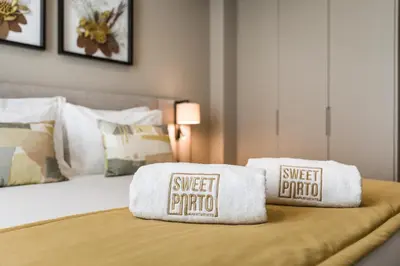 a bed with two towels on top of it at Legends House by Sweet Porto in Porto