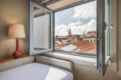 a bedroom with a window with a view of the city at Legends House by Sweet Porto in Porto