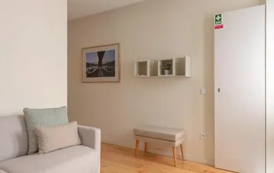 a living room with a couch and a stool at GuestReady - Catorze de Outubro Houses 423 in Vila Nova de Gaia