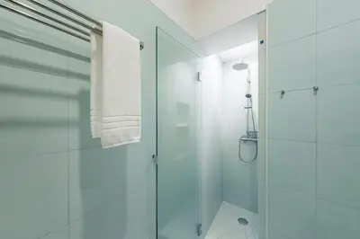 a bathroom with a shower and a glass shower stall at GuestReady - Bella's Downtown Apartment in Porto