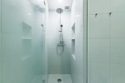 a bathroom with a shower with a glass door at GuestReady - Bella's Downtown Apartment in Porto